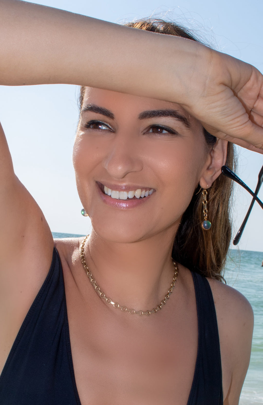 Natasa Plecas wearing PLECAS Luna Necklace and Voda Earrings in the ocean.