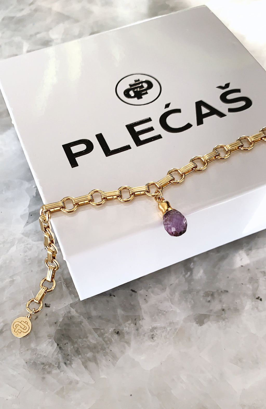 Luna Amethyst PLECAS bracelet on top of PLECAS box